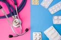 Pills, drugs, medictions and suppositories in blister package and medical stethoscope in two colors background: blue and pink. Con Royalty Free Stock Photo