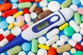 Pills and electronic thermometer 37.5 degrees - medical background Royalty Free Stock Photo