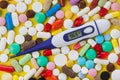 Pills and electronic thermometer 36.6 degrees - medical background