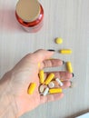 Pills in a female hand, suicide