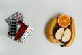 Pills and fruits on a white background Royalty Free Stock Photo