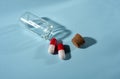 Pills in a glass jar on a light background close-up. medical preparations. vitamins. empty pill jars. chemical production