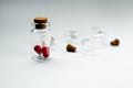 Pills in a glass jar on a light background close-up. medical preparations. vitamins. empty pill jars. chemical production