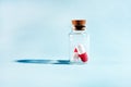 Pills in a glass jar on a light background close-up. medical preparations. vitamins. empty pill jars. chemical production