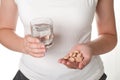 Pills and a glass of water in girl hands isolated Royalty Free Stock Photo