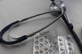 Pills on a gray table with stethoscope. Top view. Copy space. Healthcare concept Royalty Free Stock Photo