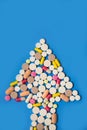 Pills in a heart shape on a blue background. Royalty Free Stock Photo