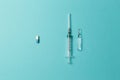 Pills or injections. Concept of different treatment methods. Medicine syringe and ampoule. Pharmaceutical tablets on blue backgrou Royalty Free Stock Photo