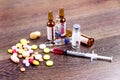 Pills, injector and ampules on wooden background Royalty Free Stock Photo