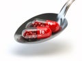 Pills with iron FE ferrum element in spoon. Dietary supplements. Royalty Free Stock Photo