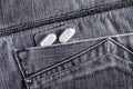 Pills in jeans pocket. Blister pack of white pills in back jeans pocket. Care health concept Royalty Free Stock Photo