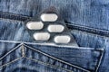 Pills in jeans pocket. Blister pack of white pills in back jeans pocket. Care health concept Royalty Free Stock Photo