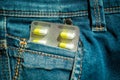 Pills in jeans pocket closeup