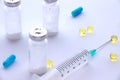 Pills medicine vials and a syringe on a blue background Royalty Free Stock Photo