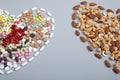 Pills and nuts different types in the shape of heart. Healthy concept