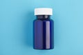 Pills package, Close up pill bottle on blue background. Medicine, medical insurance or pharmacy concept close up with copy space Royalty Free Stock Photo