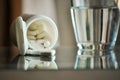 Pills with pill bottle and glass of water Royalty Free Stock Photo