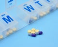 Pills and pill organizer Royalty Free Stock Photo