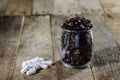 Pills in a plastic container and coffee. Coffee beans in a glass Royalty Free Stock Photo