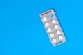 Pills plate lying on a blue background. Royalty Free Stock Photo