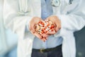 Pills for prevention and cure. Closeup shot of an unidentifiable doctor holding a variety of pills in her hands. Royalty Free Stock Photo