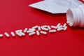 Pills and protective mask on a red background