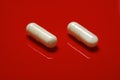 Pills on red background Royalty Free Stock Photo