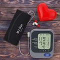 Pills and Red Heart near Modern Digital Blood Pressure Measurement Monitor Equipment. 3d Rendering Royalty Free Stock Photo