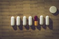 Pills in a row with a different colored one Royalty Free Stock Photo