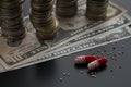 Pills with scattered contents and dollar bills Royalty Free Stock Photo