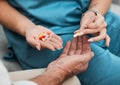 Pills, senior medication and man hands with a nurse and caregiver giving medicine at clinic. Retirement, nursing home Royalty Free Stock Photo