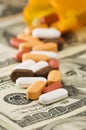 Pills spilled over money Royalty Free Stock Photo