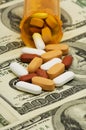 Pills spilled over money Royalty Free Stock Photo