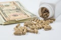 Pills spilling from Bottle with dollar money Royalty Free Stock Photo