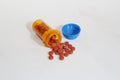 Pills spilling out of medicine bottle. Royalty Free Stock Photo