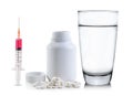 Pills spilling out of pill bottle and Glass of water Royalty Free Stock Photo