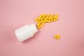 Pills spilling out of pill bottle isolated on pinck. Top view. Medicine concept Royalty Free Stock Photo