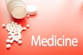 Pills spilling out of pill bottle and isolated on red. Medicine Text Top view with copy space. Medicine concept Royalty Free Stock Photo