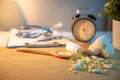 Pills spilling out of pill bottles on doctor desk Royalty Free Stock Photo