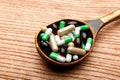 Pills in a spoon. medicines in a wooden spoon. Royalty Free Stock Photo