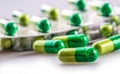 Pills. Tablets. Capsule. Heap of pills. Medical background. Close-up of pile of yellow green tablets