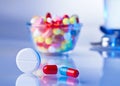 Pills and tablets macro still life on white blue