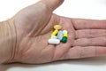 Pills and tablets medication in the palm of a mans hand Royalty Free Stock Photo