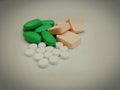 Pills tablets medicine spilled spread on surface caplets drug pharmacy medical supplements closeup view image