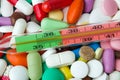 Pills and thermometer - medical background Royalty Free Stock Photo