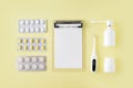 Pills, thermometer and note for recipe on yellow background. Cold and flu treatment set. Flat lay, top view Royalty Free Stock Photo