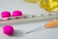 Pills and thermometer Royalty Free Stock Photo