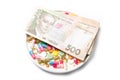 Pills and Ukrainian money on a white background. Royalty Free Stock Photo