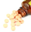 Pills of vitamin C spilled out open container Royalty Free Stock Photo