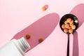 Pills or vitamins to maintain immunity on a pink background. The concept of healthcare, nutritional supplements for a healthy Royalty Free Stock Photo